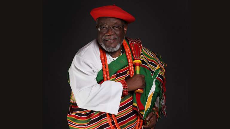 GARLANDS TO HIGH CHIEF TOM IKIMI AS HE ETCHES HIS NAME IN THE SANDS OF TIME